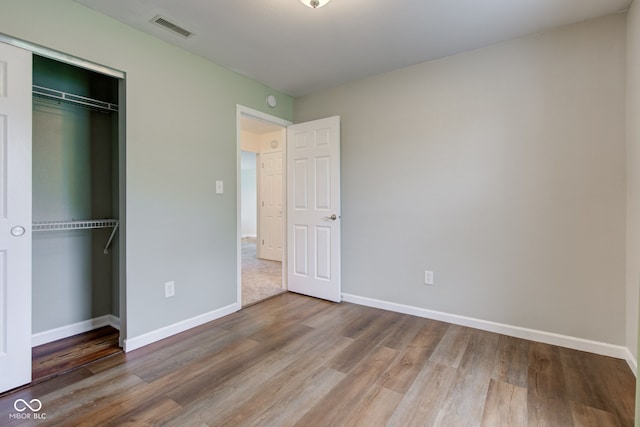 8684 Captain Dr, Avon, IN 46123 - unfurnished bedroom featuring wood finished floors, baseboards, and a closet