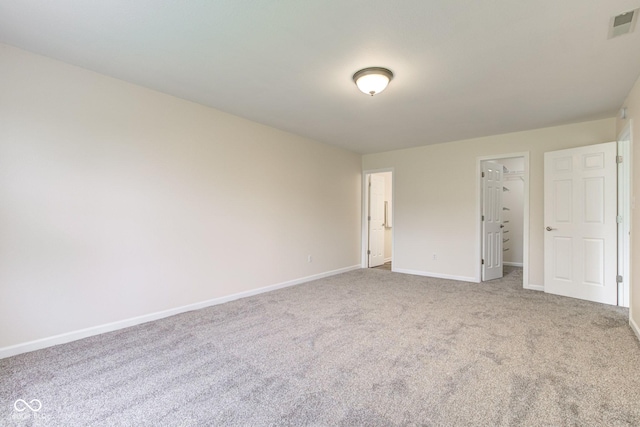 8684 Captain Dr, Avon, IN 46123 - unfurnished bedroom with baseboards, carpet floors, a walk in closet, and a closet