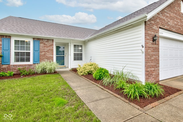8684 Captain Dr, Avon, IN 46123 - doorway to property with brick siding, roof with shingles, an attached garage, and a yard