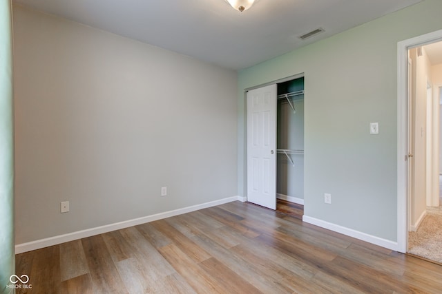 8684 Captain Dr, Avon, IN 46123 - unfurnished bedroom with wood finished floors, a closet, and baseboards