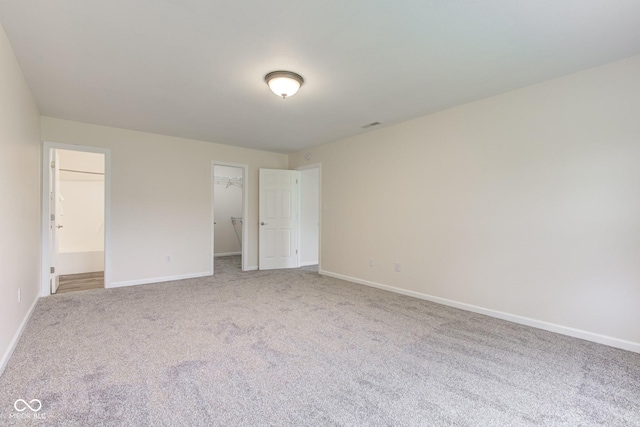 8684 Captain Dr, Avon, IN 46123 - unfurnished bedroom with a walk in closet, carpet floors, baseboards, and a closet