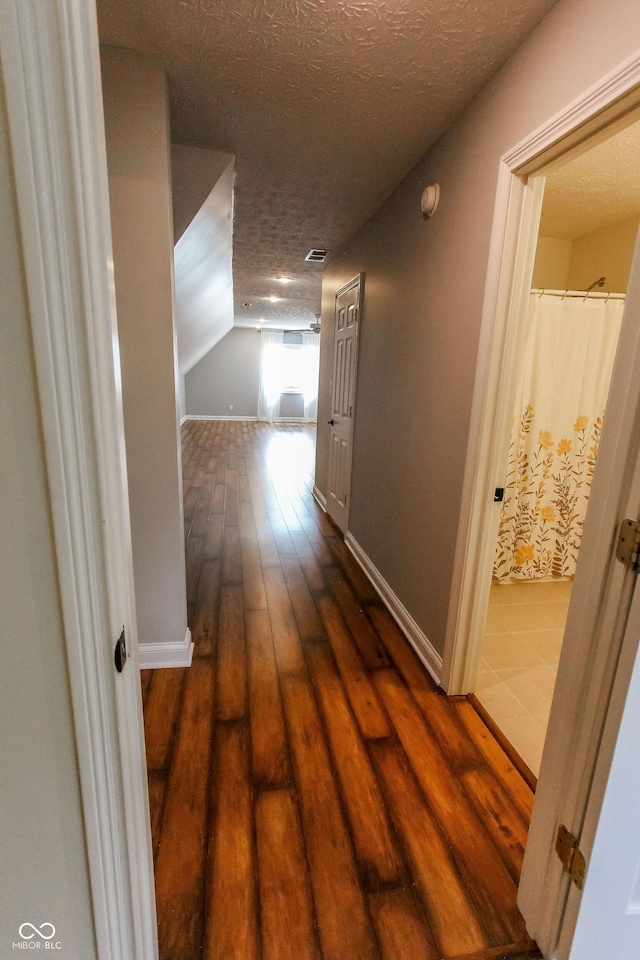 7093 Republic Ln, Indianapolis, IN 46259 - hallway with a textured ceiling, hardwood / wood-style flooring, lofted ceiling, and baseboards