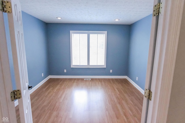 7093 Republic Ln, Indianapolis, IN 46259 - empty room featuring a textured ceiling, wood finished floors, baseboards, and recessed lighting