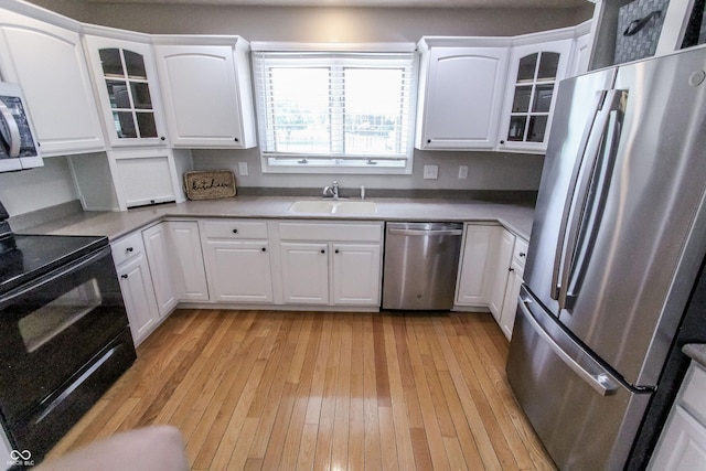 7093 Republic Ln, Indianapolis, IN 46259 - kitchen with stainless steel appliances, a sink, light wood finished floors, glass insert cabinets, and white cabinets