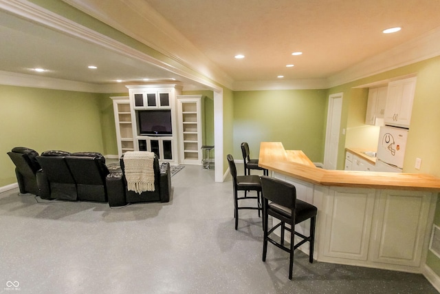 7093 Republic Ln, Indianapolis, IN 46259 - indoor wet bar featuring crown molding, baseboards, recessed lighting, concrete flooring, and refrigerator