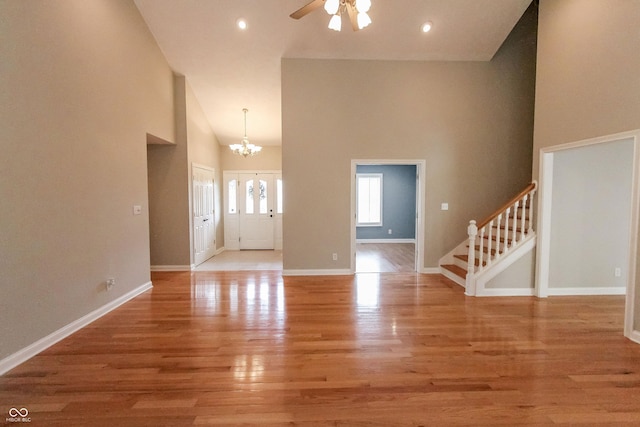 7093 Republic Ln, Indianapolis, IN 46259 - entrance foyer with stairs, a ceiling fan, a chandelier, a high ceiling, and light wood-style flooring