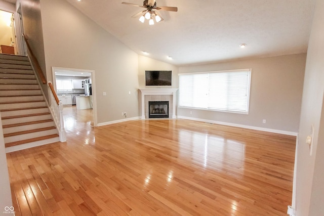 7093 Republic Ln, Indianapolis, IN 46259 - unfurnished living room featuring stairway, light wood-style floors, a ceiling fan, a fireplace, and baseboards