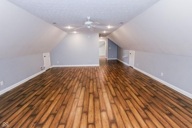 7093 Republic Ln, Indianapolis, IN 46259 - additional living space with dark wood-type flooring, ceiling fan, lofted ceiling, baseboards, and a textured ceiling