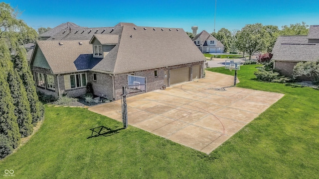 7093 Republic Ln, Indianapolis, IN 46259 - back of house featuring brick siding, driveway, an attached garage, a lawn, and a shingled roof