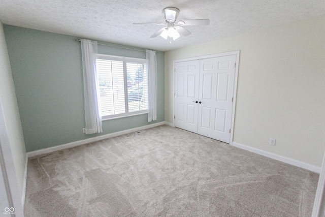 7093 Republic Ln, Indianapolis, IN 46259 - unfurnished bedroom featuring carpet flooring, baseboards, a closet, a textured ceiling, and a ceiling fan