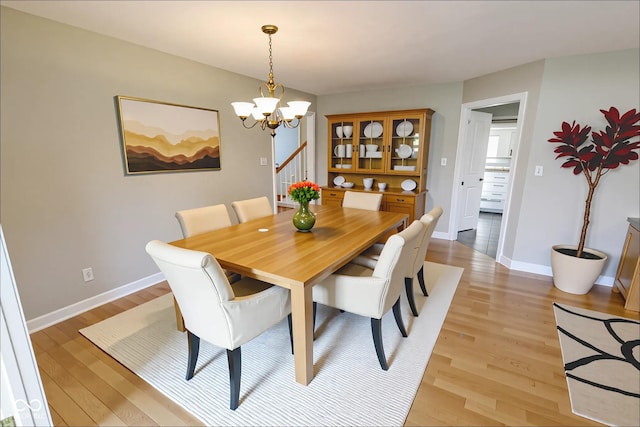 7093 Republic Ln, Indianapolis, IN 46259 - dining room featuring a chandelier, light wood-type flooring, and stairway