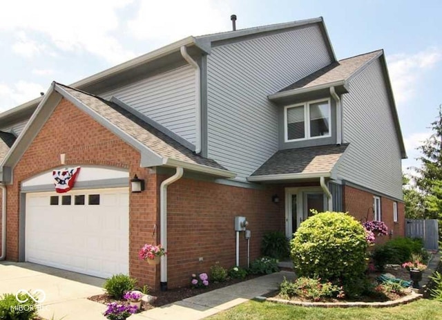 213 Golf Ct, Greenwood, IN 46143 - view of front of home with a garage, driveway, and brick siding