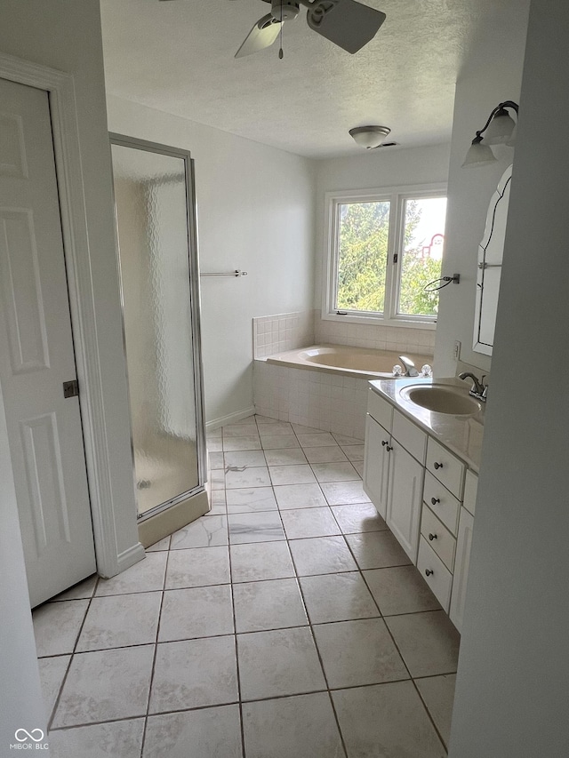 213 Golf Ct, Greenwood, IN 46143 - bathroom featuring a stall shower, vanity, ceiling fan, a garden tub, and a textured ceiling