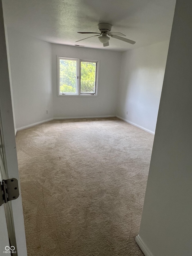 213 Golf Ct, Greenwood, IN 46143 - spare room featuring carpet and a ceiling fan
