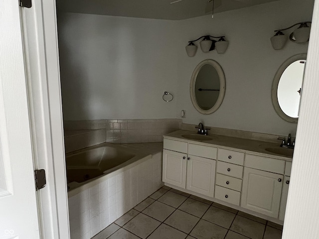213 Golf Ct, Greenwood, IN 46143 - bathroom featuring tile patterned flooring, a relaxing tiled tub, and double vanity