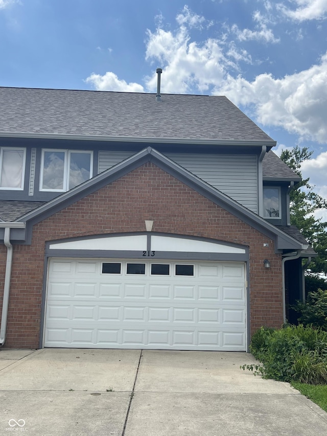 213 Golf Ct, Greenwood, IN 46143 - view of property exterior featuring driveway, a garage, and a shingled roof