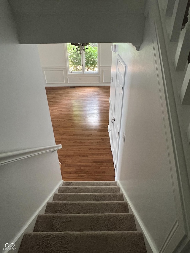213 Golf Ct, Greenwood, IN 46143 - stairs with wood finished floors and a chandelier
