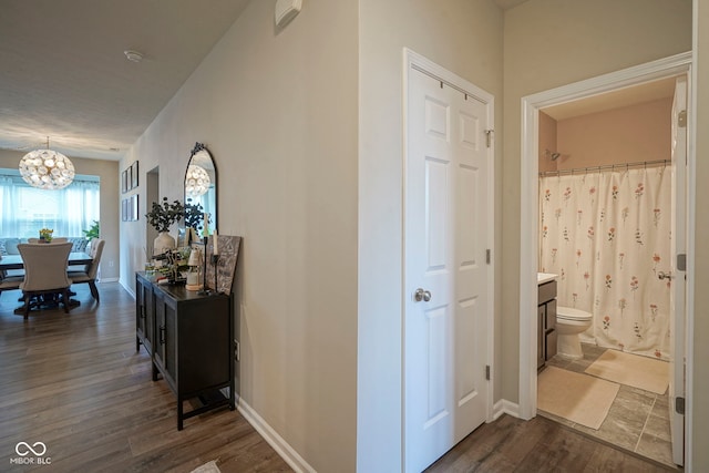 19144 Goins Blvd, Westfield, IN 46074 - hall with a chandelier, dark wood-style flooring, and baseboards
