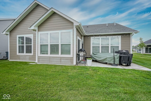 19144 Goins Blvd, Westfield, IN 46074 - back of property featuring a lawn, a patio area, and roof with shingles