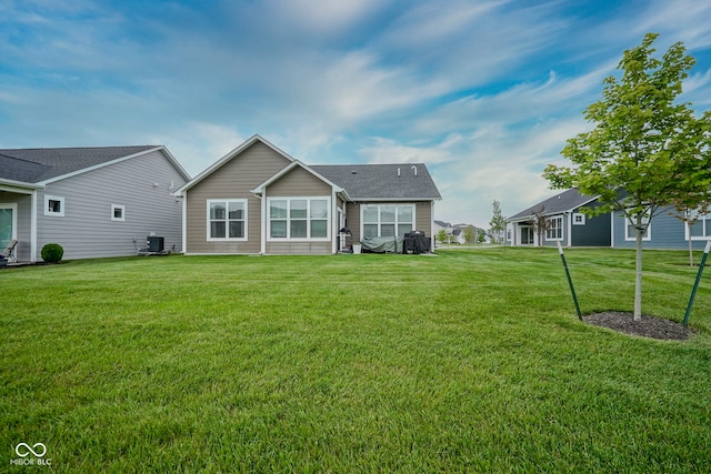 19144 Goins Blvd, Westfield, IN 46074 - back of property featuring a lawn and central AC