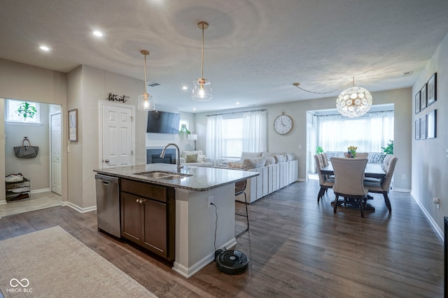 19144 Goins Blvd, Westfield, IN 46074 - kitchen with a sink, dishwasher, a center island with sink, light stone counters, and dark wood-type flooring