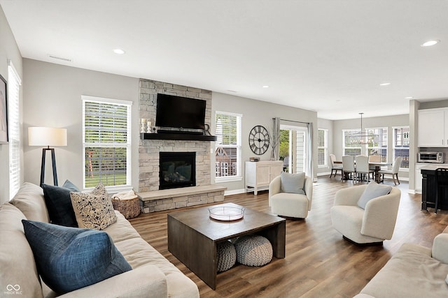 4602 Hayward Way, Westfield, IN 46062 - living area featuring a stone fireplace, plenty of natural light, wood finished floors, and recessed lighting
