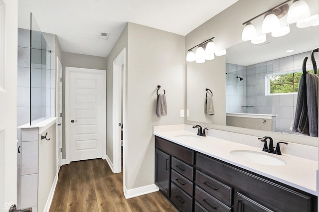 4602 Hayward Way, Westfield, IN 46062 - bathroom featuring a walk in shower, wood finished floors, baseboards, and double vanity