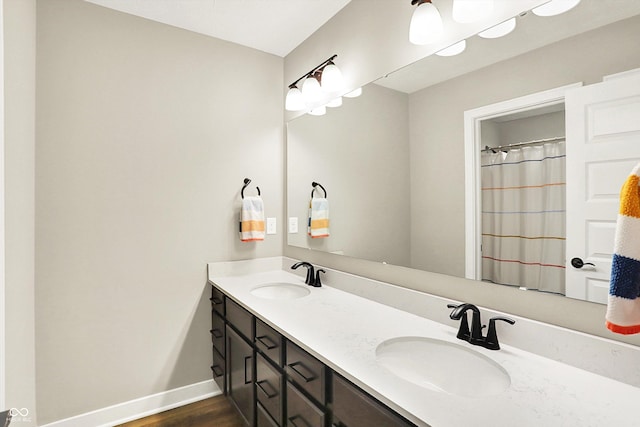 4602 Hayward Way, Westfield, IN 46062 - full bathroom featuring double vanity, baseboards, and wood finished floors