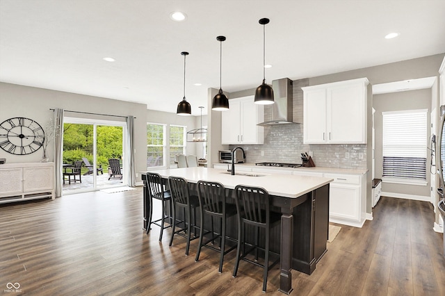 4602 Hayward Way, Westfield, IN 46062 - kitchen featuring wall chimney range hood, a sink, an island with sink, dark wood finished floors, and recessed lighting