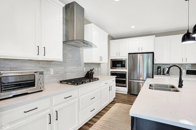 4602 Hayward Way, Westfield, IN 46062 - kitchen featuring stainless steel appliances, wall chimney exhaust hood, a sink, decorative backsplash, and hanging light fixtures