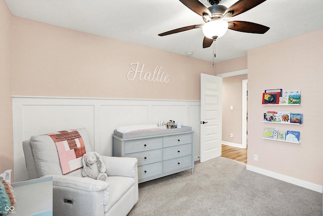 4602 Hayward Way, Westfield, IN 46062 - living area with light colored carpet, a ceiling fan, and a wainscoted wall