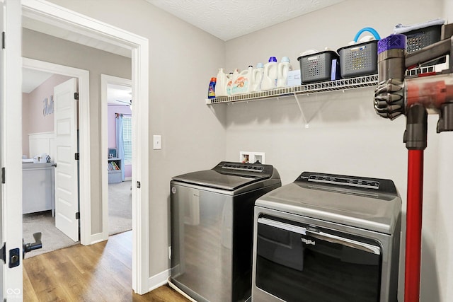 4602 Hayward Way, Westfield, IN 46062 - laundry area with washing machine and clothes dryer, wood finished floors, and baseboards