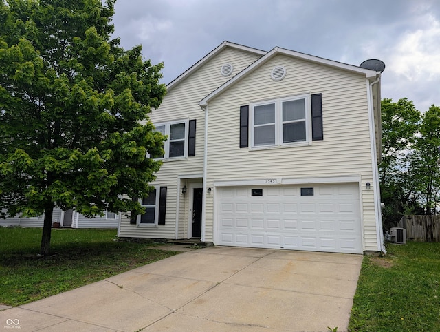 11343 Congaree Way, Indianapolis, IN 46235 - view of front of home featuring central AC, an attached garage, driveway, and a front lawn