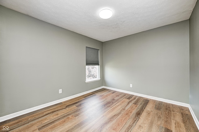 1306 Flat Wood Ct, Brownsburg, IN 46112 - empty room featuring wood finished floors and a textured ceiling
