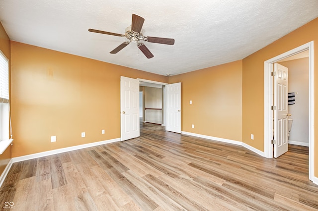1306 Flat Wood Ct, Brownsburg, IN 46112 - unfurnished room with light wood-type flooring, ceiling fan, and a textured ceiling