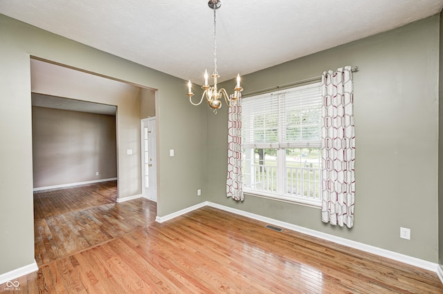 1306 Flat Wood Ct, Brownsburg, IN 46112 - spare room featuring a chandelier and wood finished floors