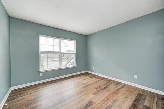 1306 Flat Wood Ct, Brownsburg, IN 46112 - spare room featuring wood finished floors and baseboards