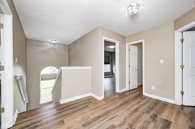 1306 Flat Wood Ct, Brownsburg, IN 46112 - foyer with wood finished floors and a textured ceiling