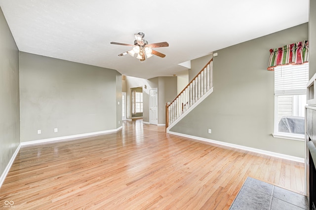1306 Flat Wood Ct, Brownsburg, IN 46112 - unfurnished living room with a ceiling fan, wood finished floors, and stairway