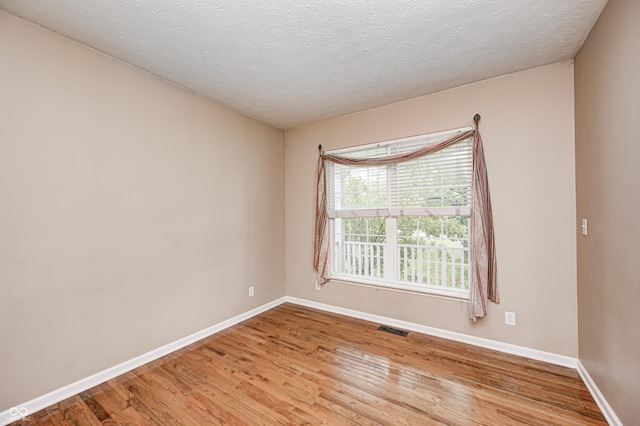 1306 Flat Wood Ct, Brownsburg, IN 46112 - unfurnished room featuring light wood-style floors and a textured ceiling