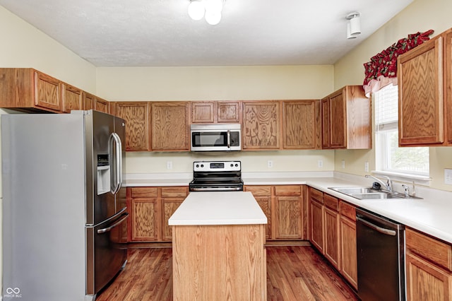1306 Flat Wood Ct, Brownsburg, IN 46112 - kitchen featuring stainless steel appliances, a center island, dark wood-style flooring, and light countertops