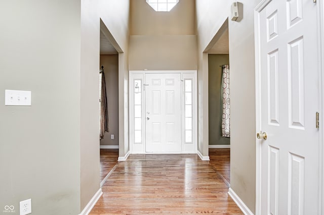 1306 Flat Wood Ct, Brownsburg, IN 46112 - foyer with light wood-style flooring and a towering ceiling