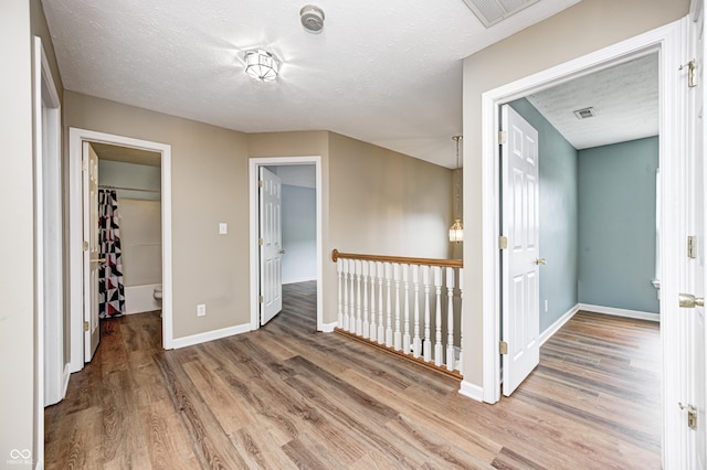 1306 Flat Wood Ct, Brownsburg, IN 46112 - hallway with wood finished floors and a textured ceiling
