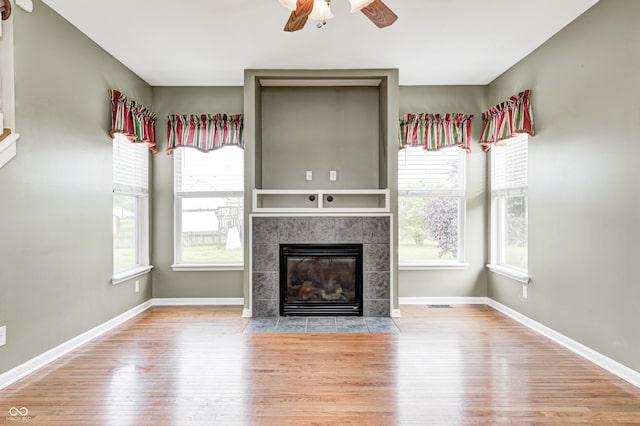 1306 Flat Wood Ct, Brownsburg, IN 46112 - unfurnished living room featuring hardwood / wood-style floors, a ceiling fan, and a tile fireplace