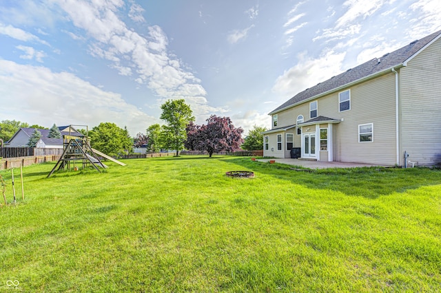 1306 Flat Wood Ct, Brownsburg, IN 46112 - fenced backyard with a playground, a patio area, and a fire pit