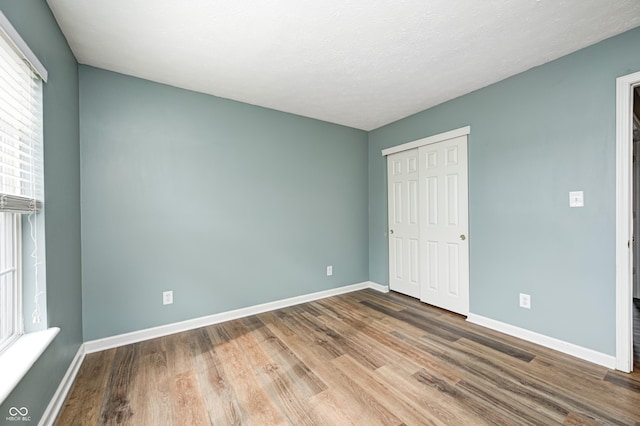 1306 Flat Wood Ct, Brownsburg, IN 46112 - unfurnished bedroom featuring wood finished floors and a closet