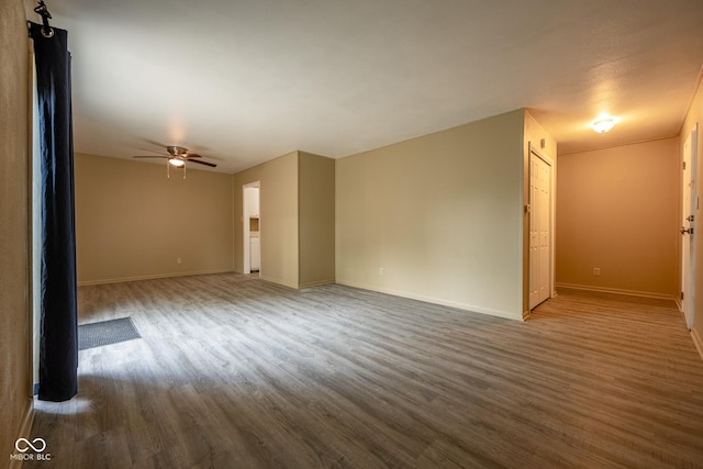 6 Heritage Dr, Terre Haute, IN 47803 - empty room with wood finished floors, a ceiling fan, and baseboards