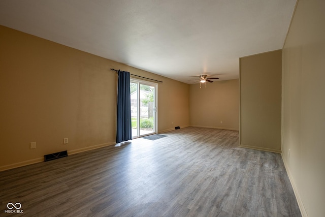 6 Heritage Dr, Terre Haute, IN 47803 - unfurnished room with wood finished floors, a ceiling fan, and baseboards