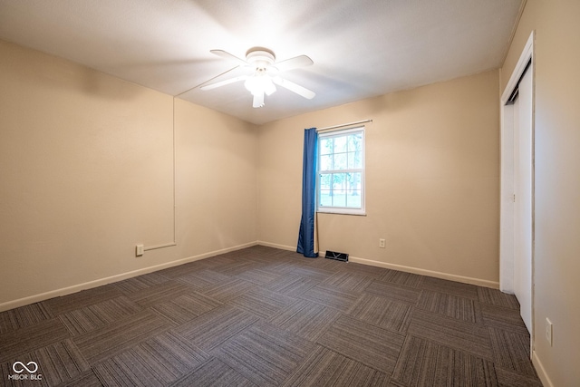 6 Heritage Dr, Terre Haute, IN 47803 - unfurnished bedroom with dark carpet, baseboards, and a ceiling fan