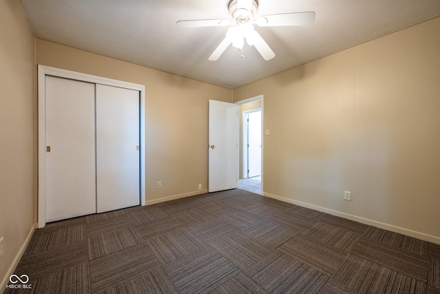 6 Heritage Dr, Terre Haute, IN 47803 - unfurnished bedroom with dark colored carpet, baseboards, a closet, and a ceiling fan